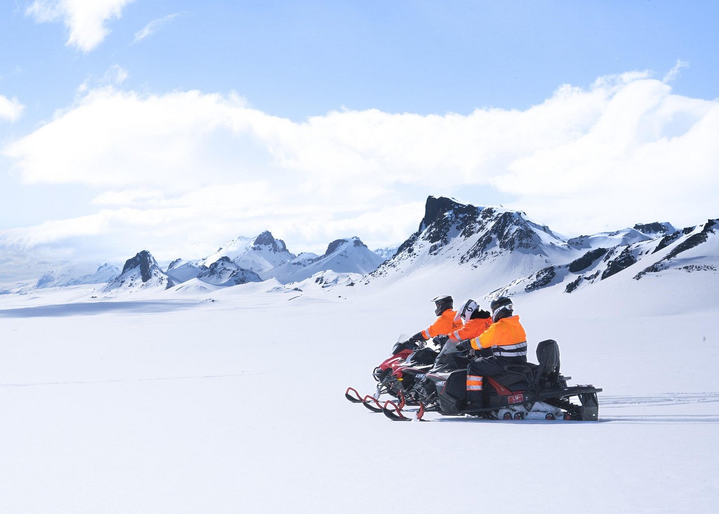 Snowmobiles crossing the open snowfields of the Langjokull ice cap